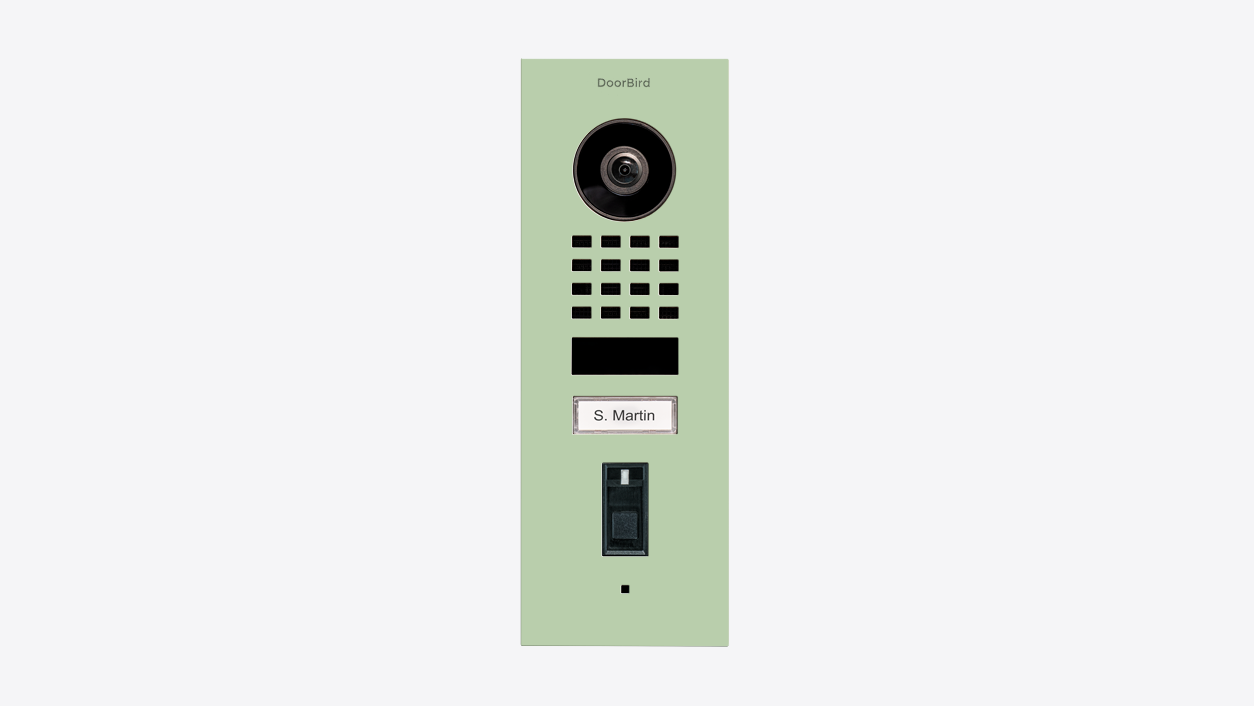 Pastel green flush-mount video door station with round camera lens and speaker grille