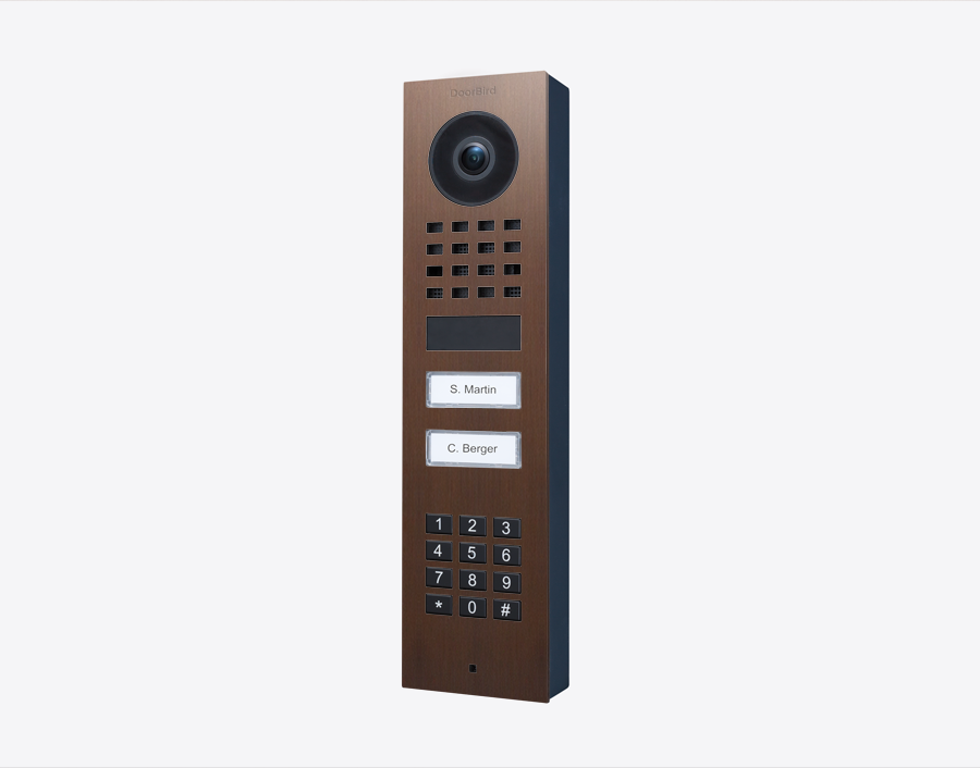 DoorBird surface-mount video door station in bronze with camera, keypad, two call buttons