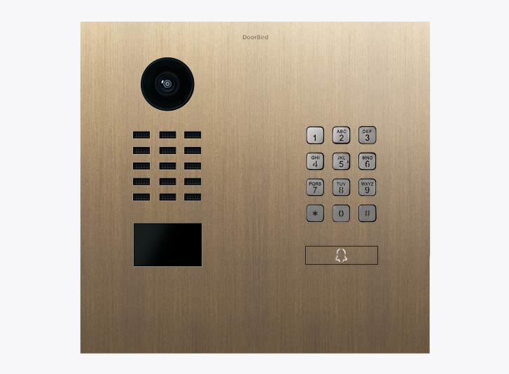 DoorBird brass IP video door station with camera lens and numeric keypad