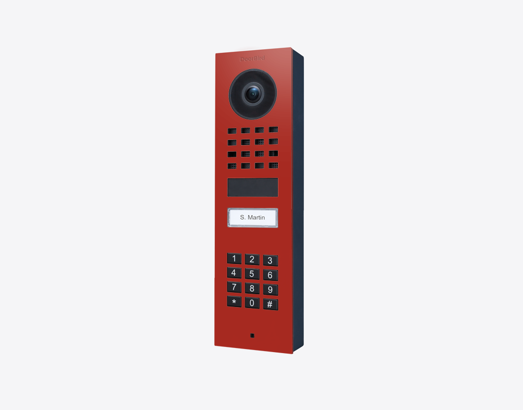 DoorBird surface-mount IP video door station in flame red with camera lens and keypad