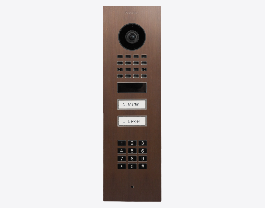 DoorBird bronze flush-mount video door station with camera, keypad, and two call buttons