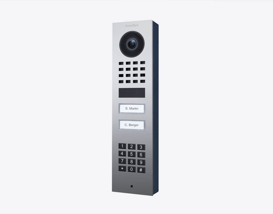 DoorBird surface-mount video door station with camera lens, keypad, and two call buttons