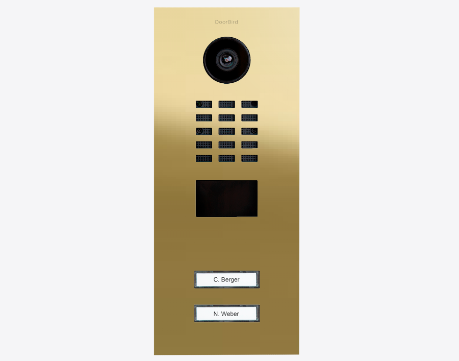 DoorBird brass IP video door station with camera lens, keypad grid, and two call buttons