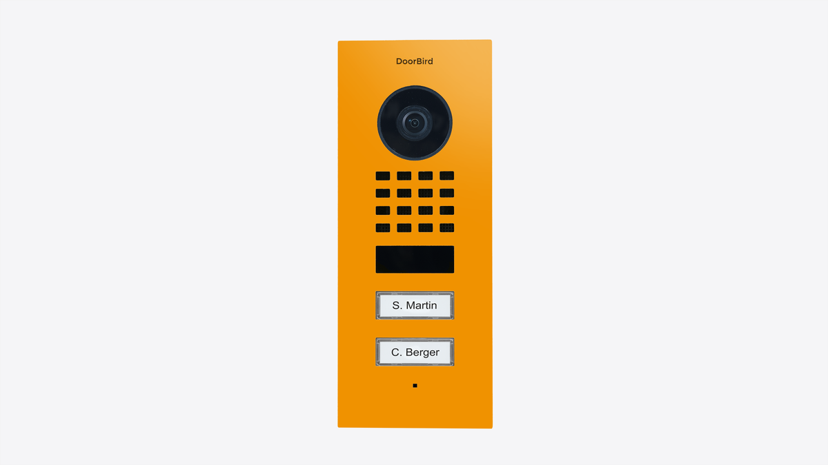 DoorBird flush-mount video door station in sun yellow with camera lens and call buttons