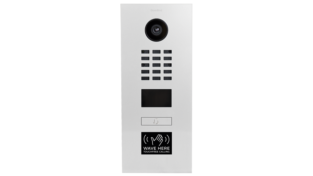 DoorBird flush-mount video door station with camera, keypad, and call button on white panel