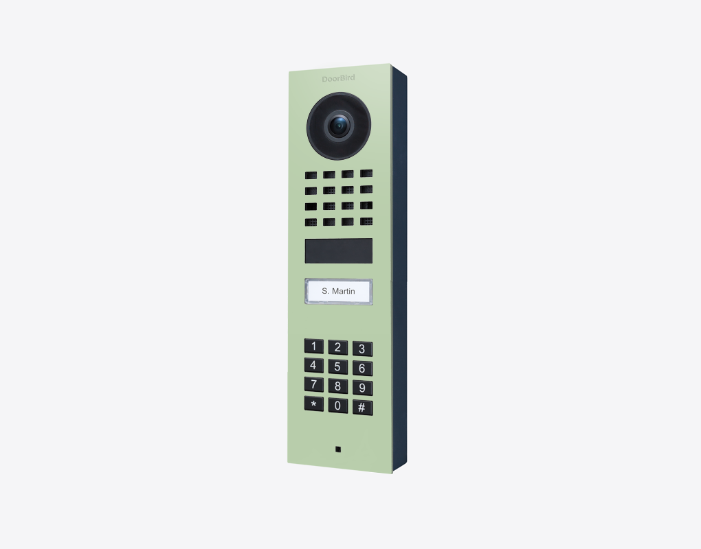 DoorBird surface-mount video door station in pastel green with camera and keypad