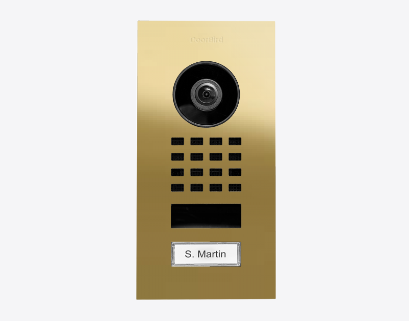 DoorBird brass flush-mount IP video intercom with camera, keypad grid, and nameplate