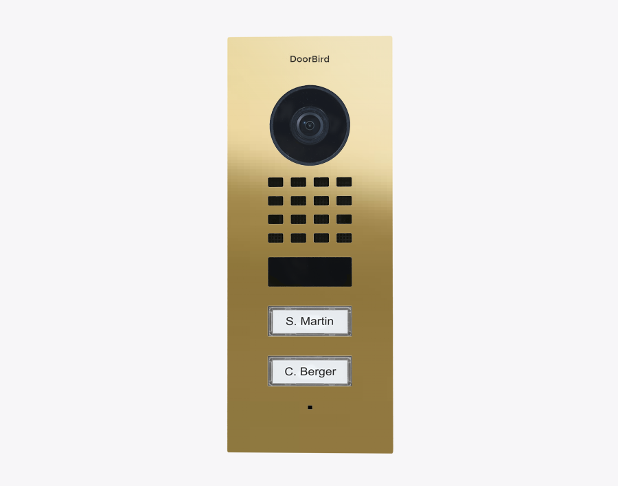 Brass flush-mount video door station with camera lens, keypad, and nameplate labels