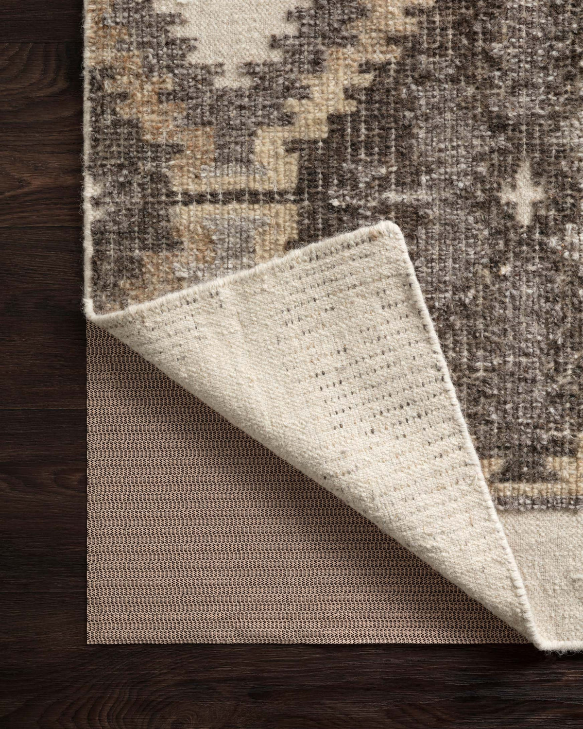 Beige textured secure grip rug pad with dense backing and folded edge