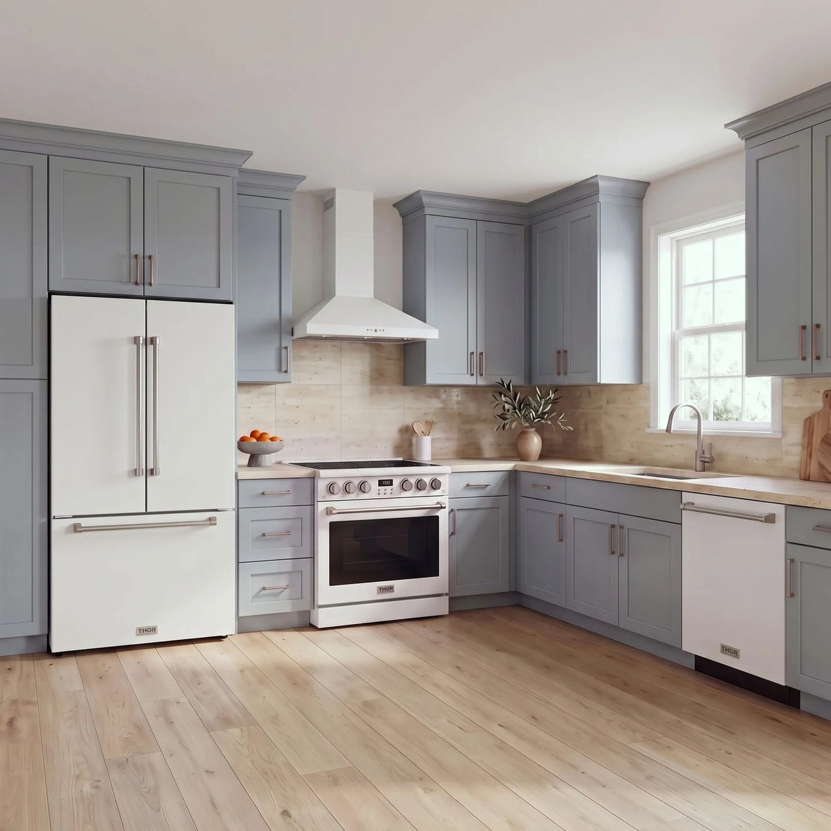 Thor Kitchen A-Series white kitchen with a 36-inch electric range, wall-mount chimney hood, French door refrigerator, dishwasher