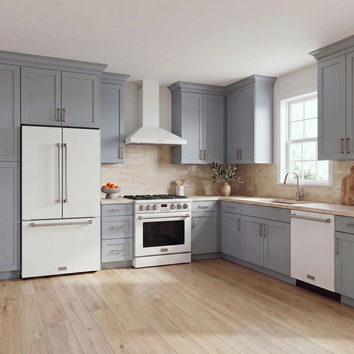 Thor Kitchen A-Series white kitchen with a 36-inch gas range, wall-mount chimney hood, French door refrigerator, dishwasher