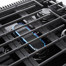 Stainless steel gas range cooktop with lit burners and cast-iron grates