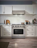 Stainless steel gas range in a kitchen with oven door and burner controls