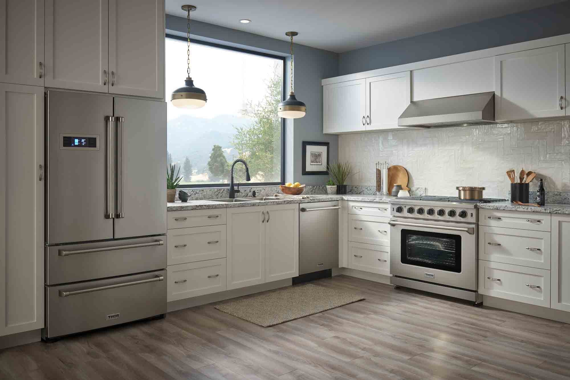 Stainless steel professional gas range in a modern kitchen with side refrigerator