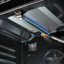 Gas oven burner area with blue flame inside the stainless steel oven