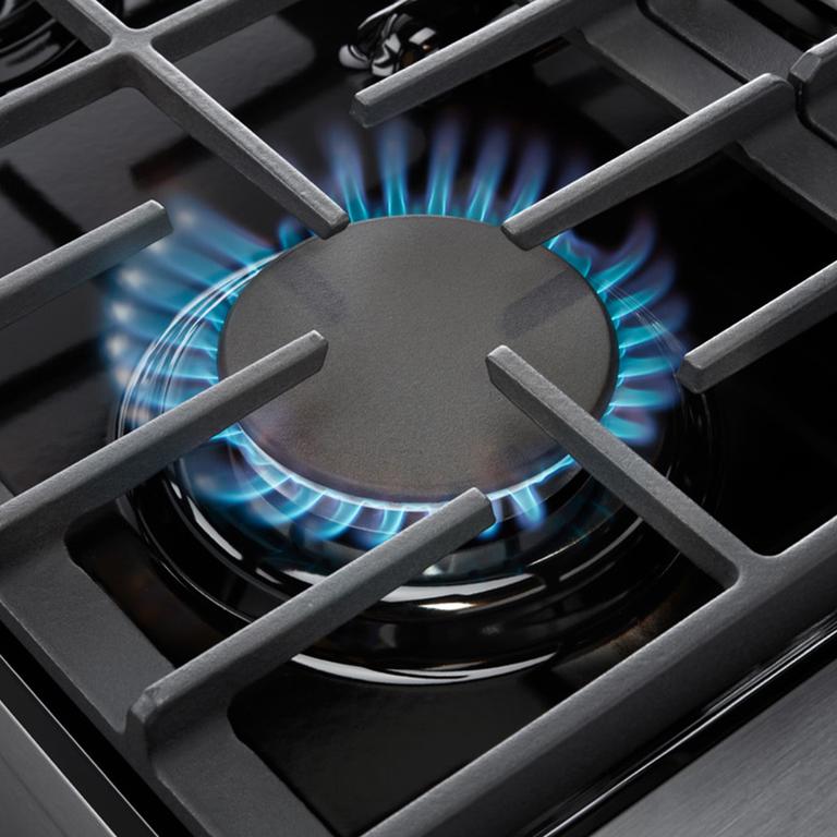 Stainless steel gas cooktop burner with blue flame and cast-iron grates