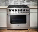 Stainless steel gas range front view with row of cooktop knobs and oven window