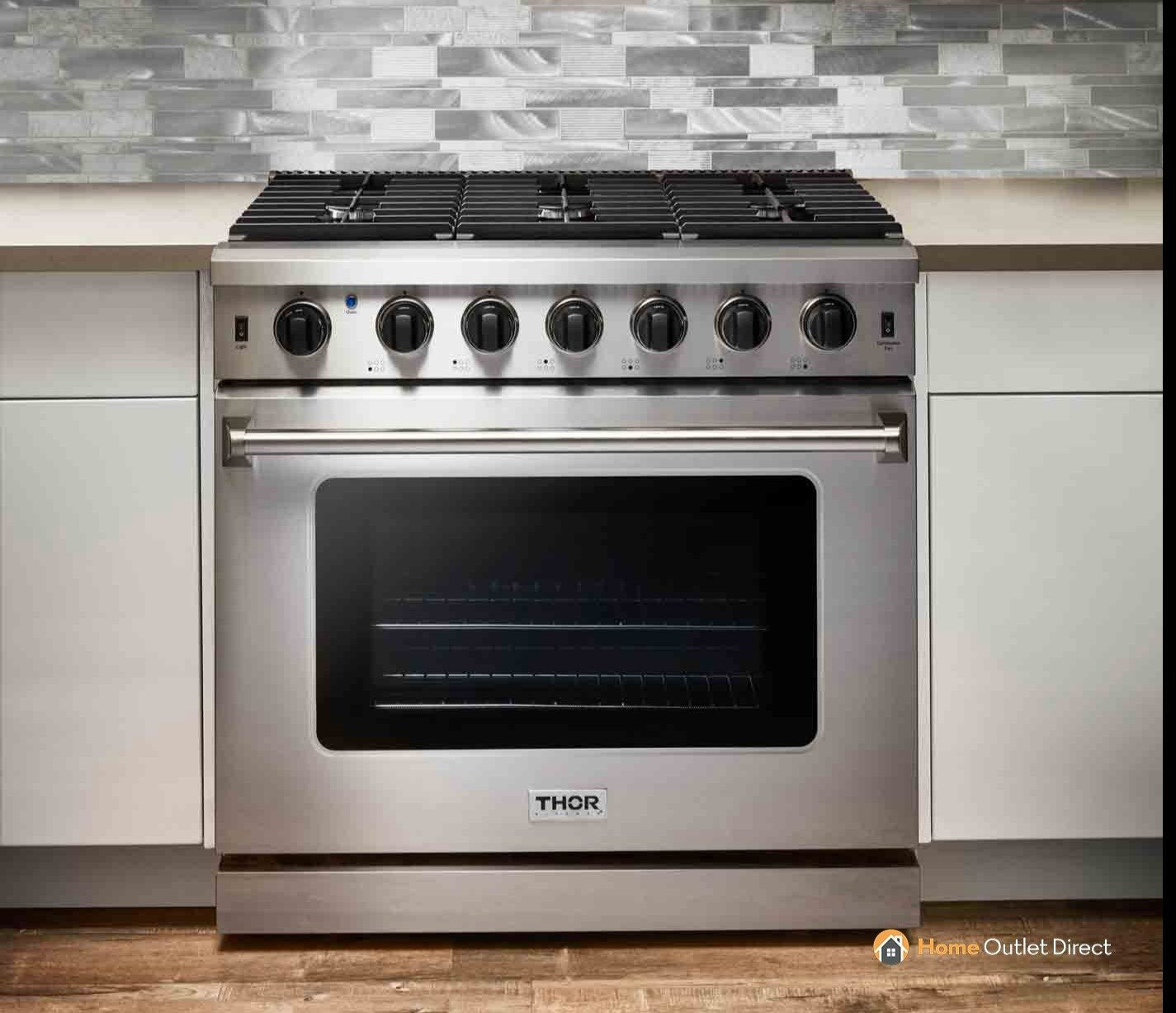 Stainless steel gas range front view with row of cooktop knobs and oven window
