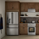 Stainless steel French door refrigerator with water dispenser, installed in kitchen