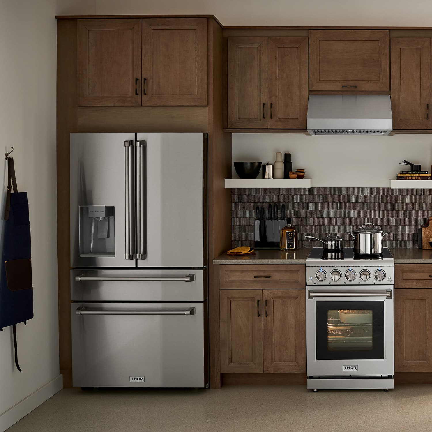Stainless steel French door refrigerator with water dispenser, installed in kitchen