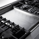 Stainless steel cooktop with black burner grates on a double oven gas range