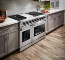 Stainless steel double oven gas range with front knobs, burner grates, and two oven doors