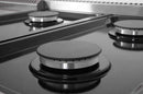 Gas cooktop with black burner caps on a stainless steel surface