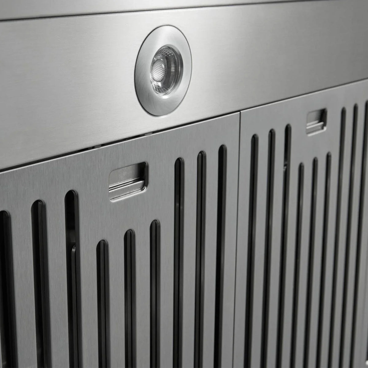 Stainless steel range hood front grille with a round light and vertical vent slots