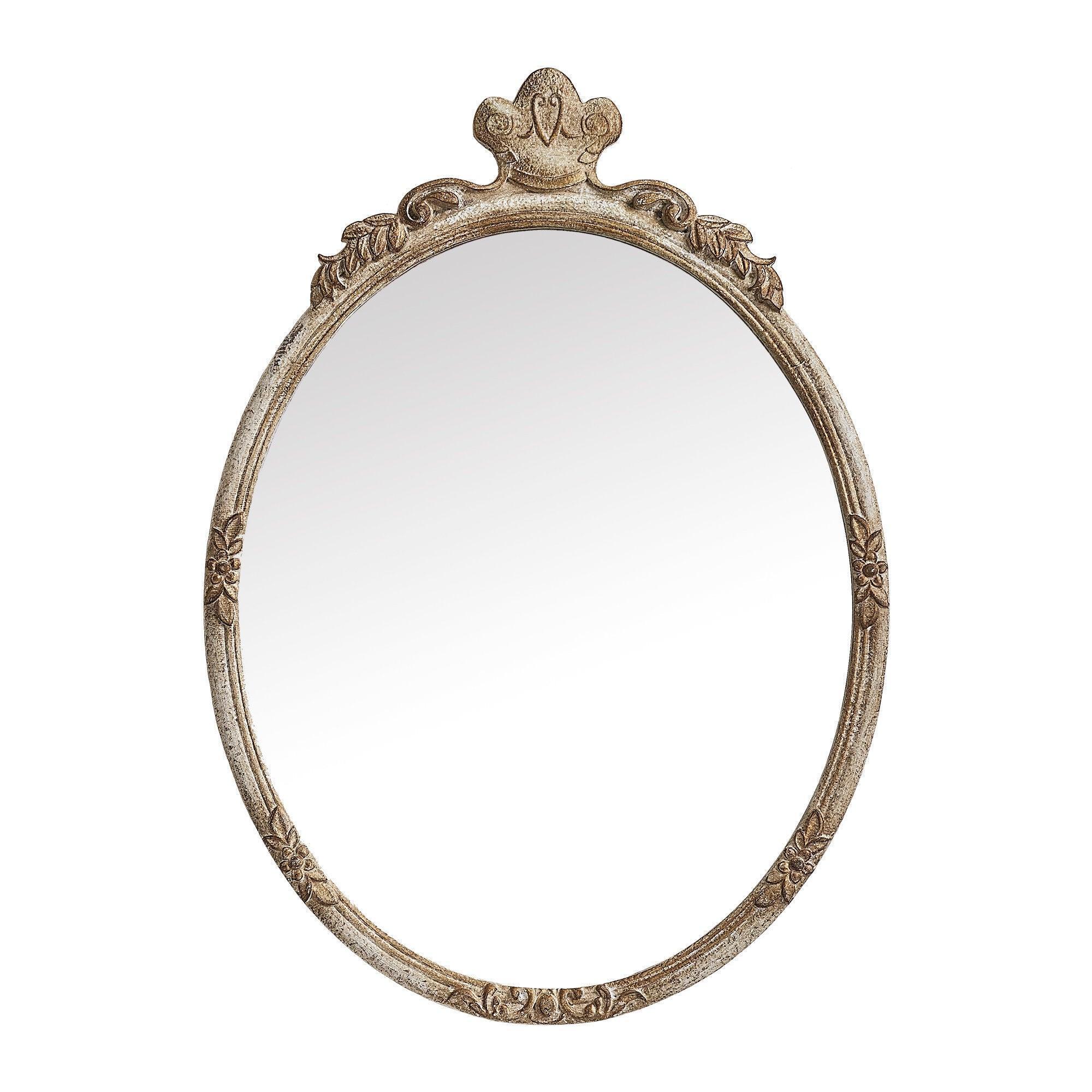 Oval wall mirror with ornate distressed wood frame and crown-like top centerpiece.