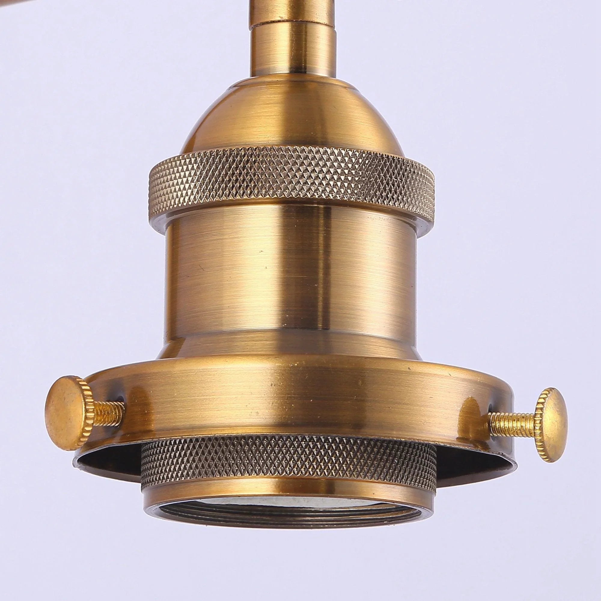 Golden lamp socket housing with textured bands on the top of a 1-light wall sconce