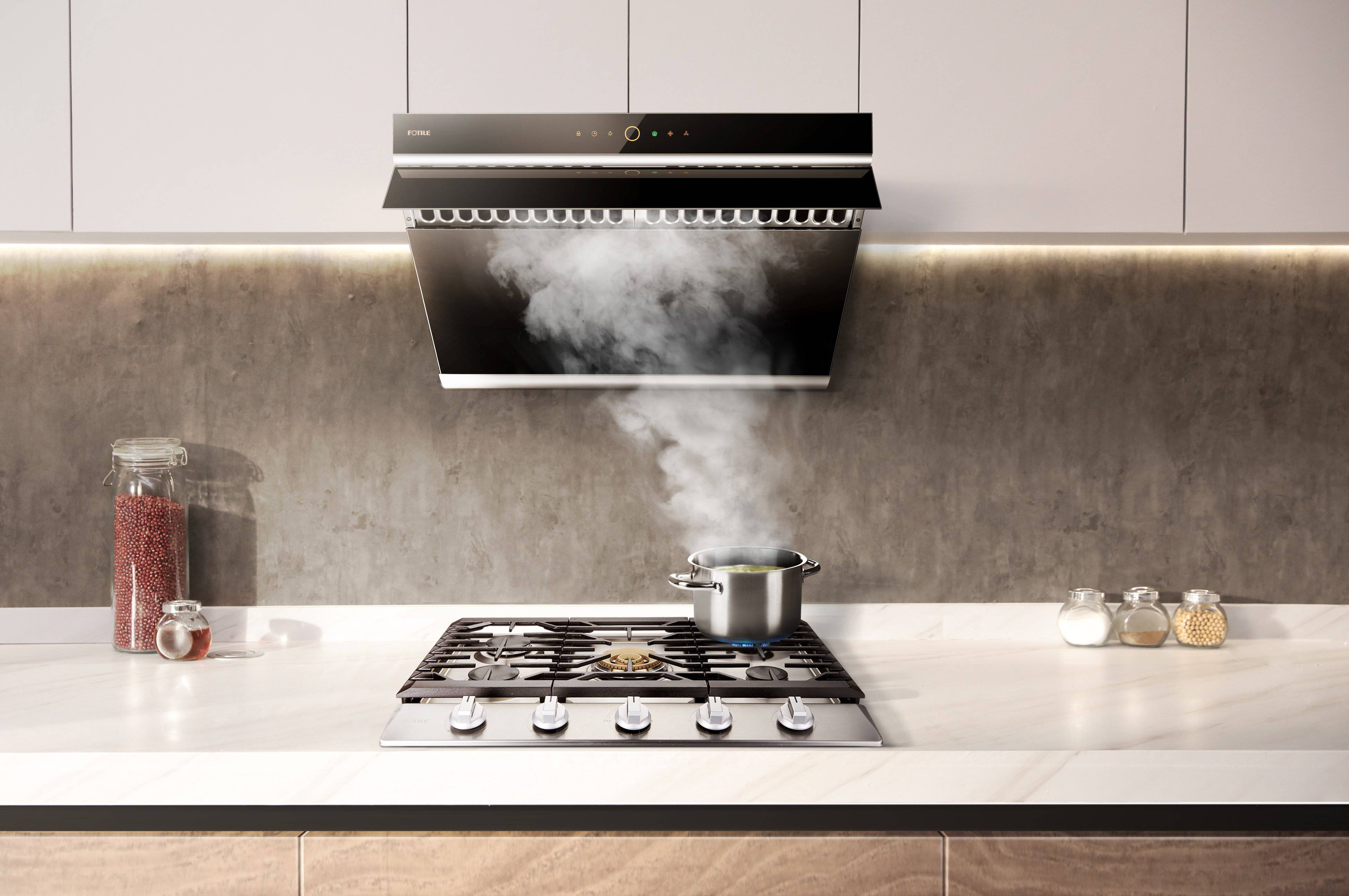 Stainless steel gas cooktop on countertop with black grates and multiple burners visible