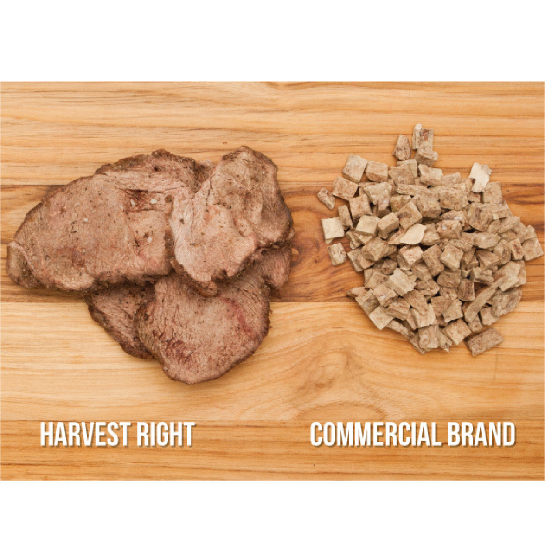 Freeze dryer food sample: brown meat pieces and chopped dried meat on a wooden board