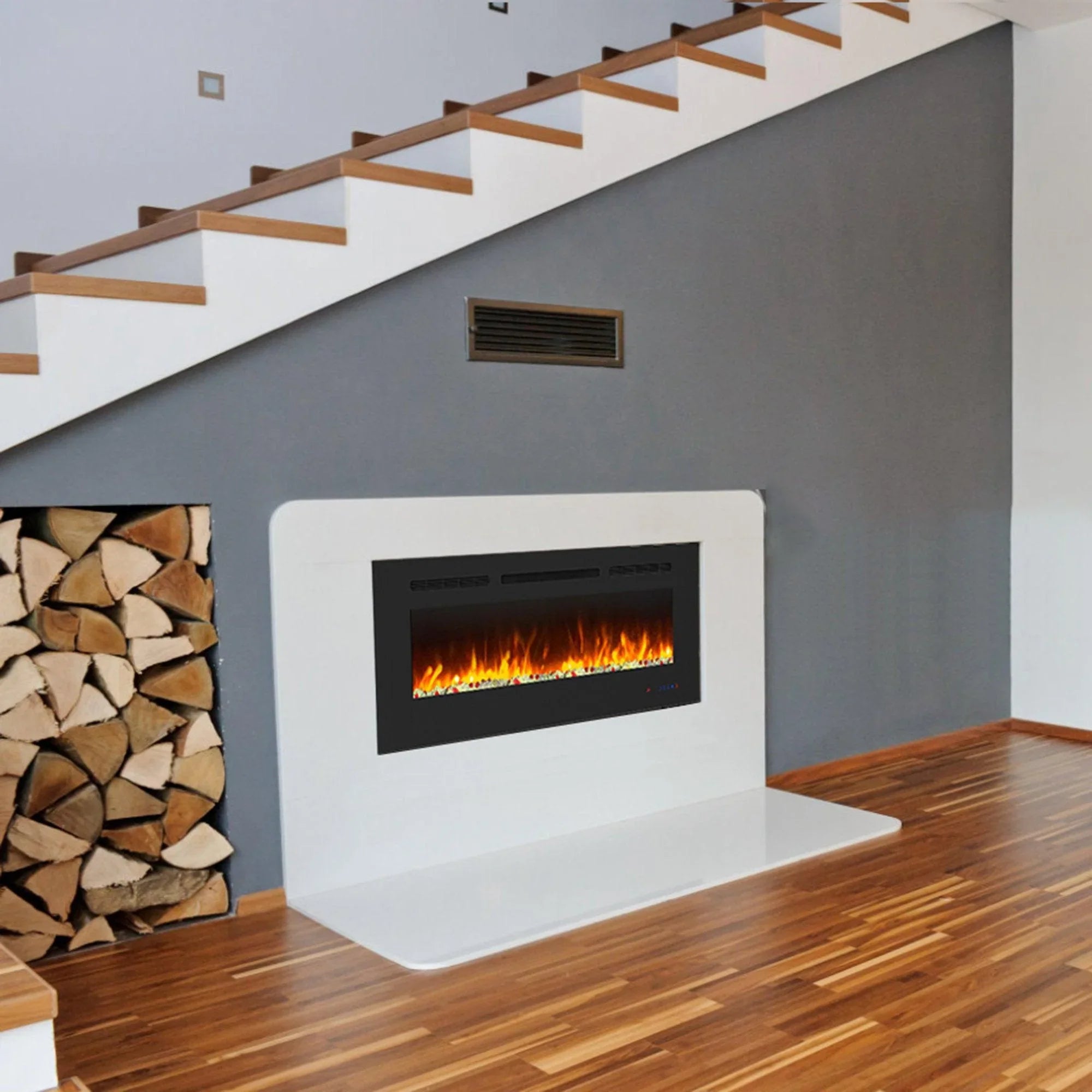 Electric fireplace insert with orange flames in white surround and black firebox