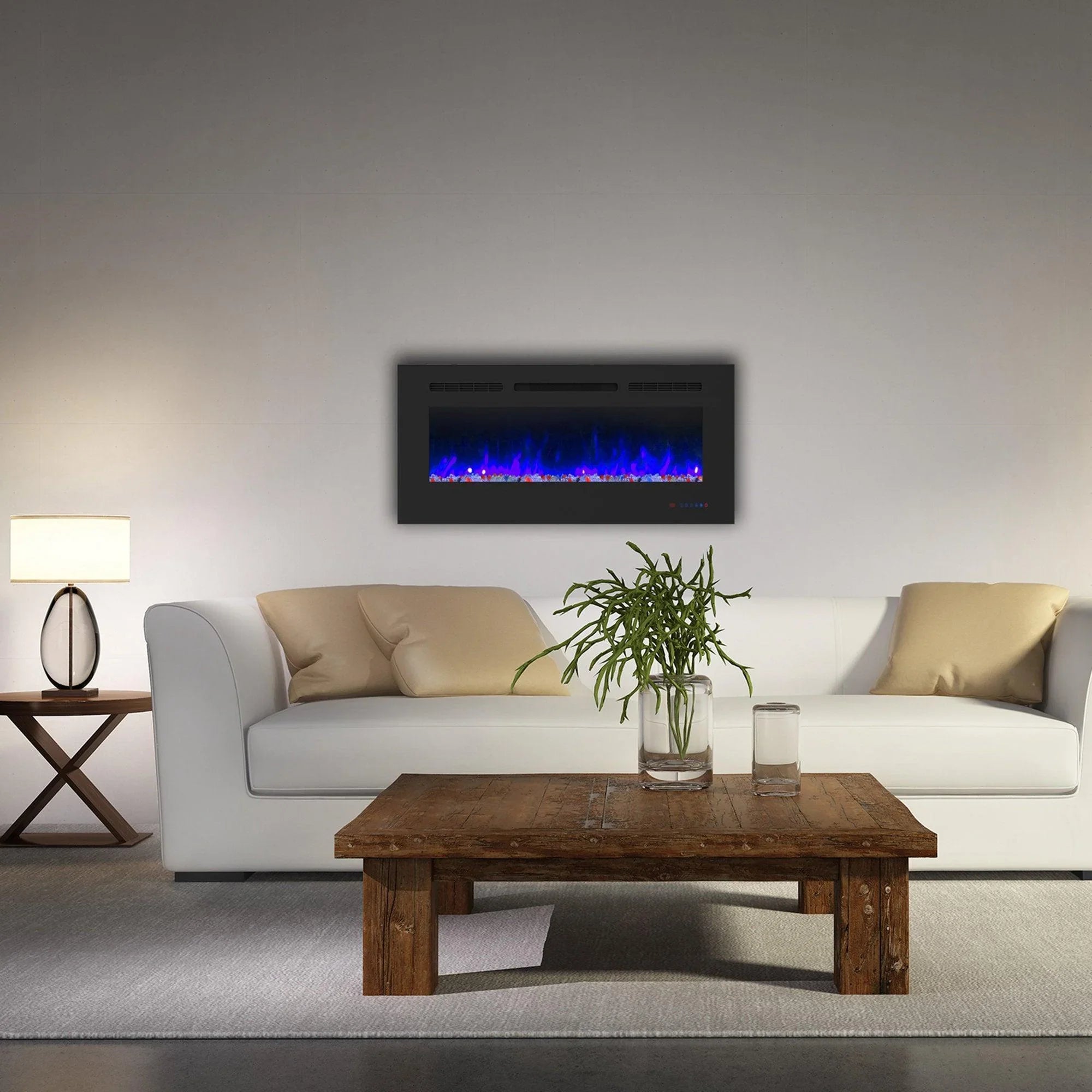 Black electric fireplace with blue flame effect mounted above a wooden coffee table