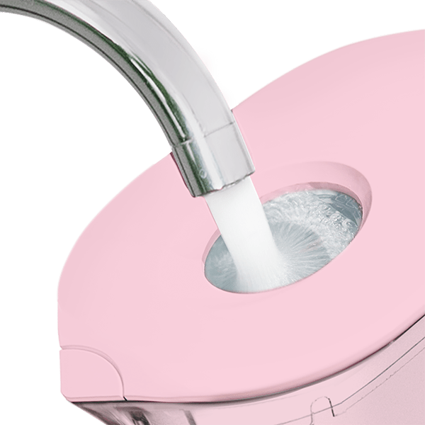 Pink water filter pitcher lid opening with stainless-steel spout and water stream