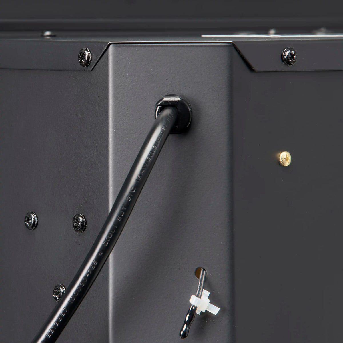 Close-up of black firebox side panel with metal lever handle and key slot