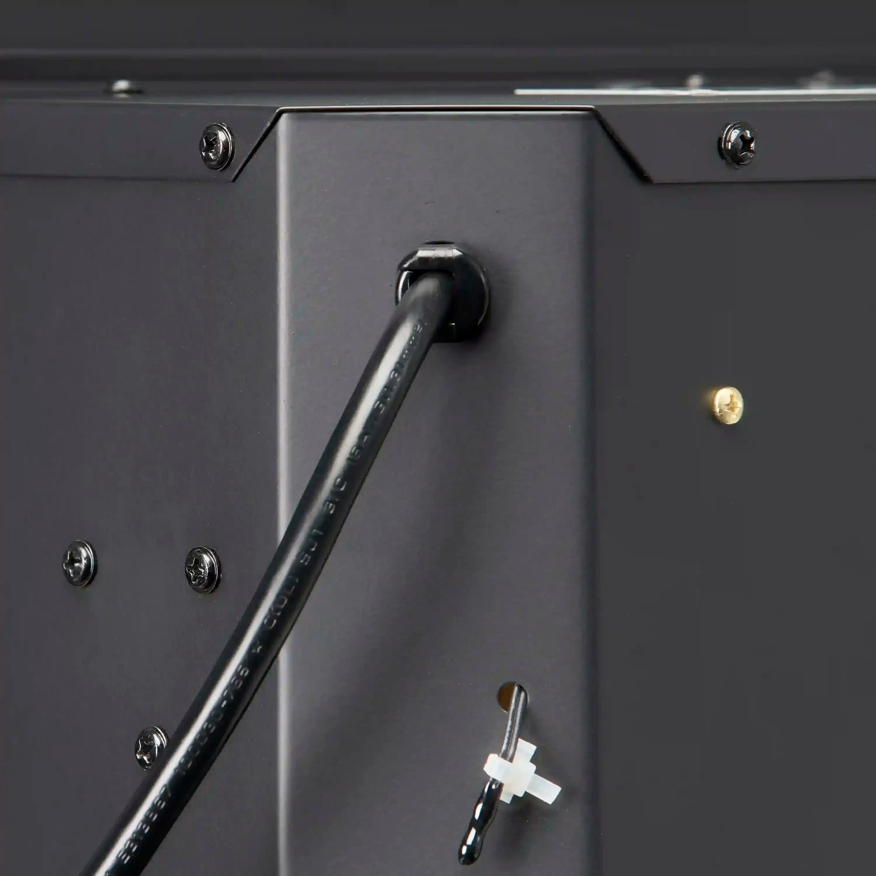 Electric firebox handle and latch on dark metal frame with mounting screws