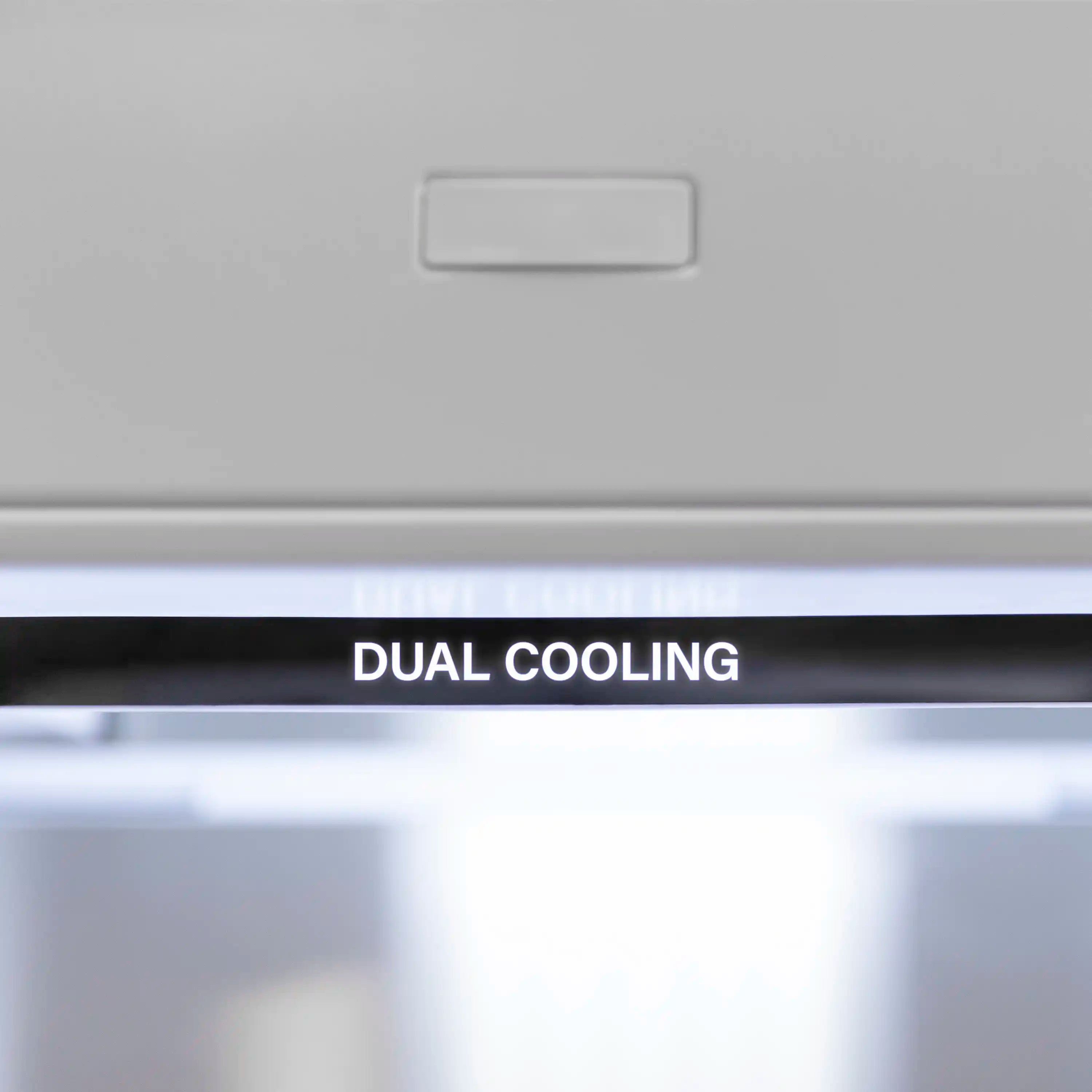 Bottom freezer refrigerator front vent area labeled “DUAL COOLING”