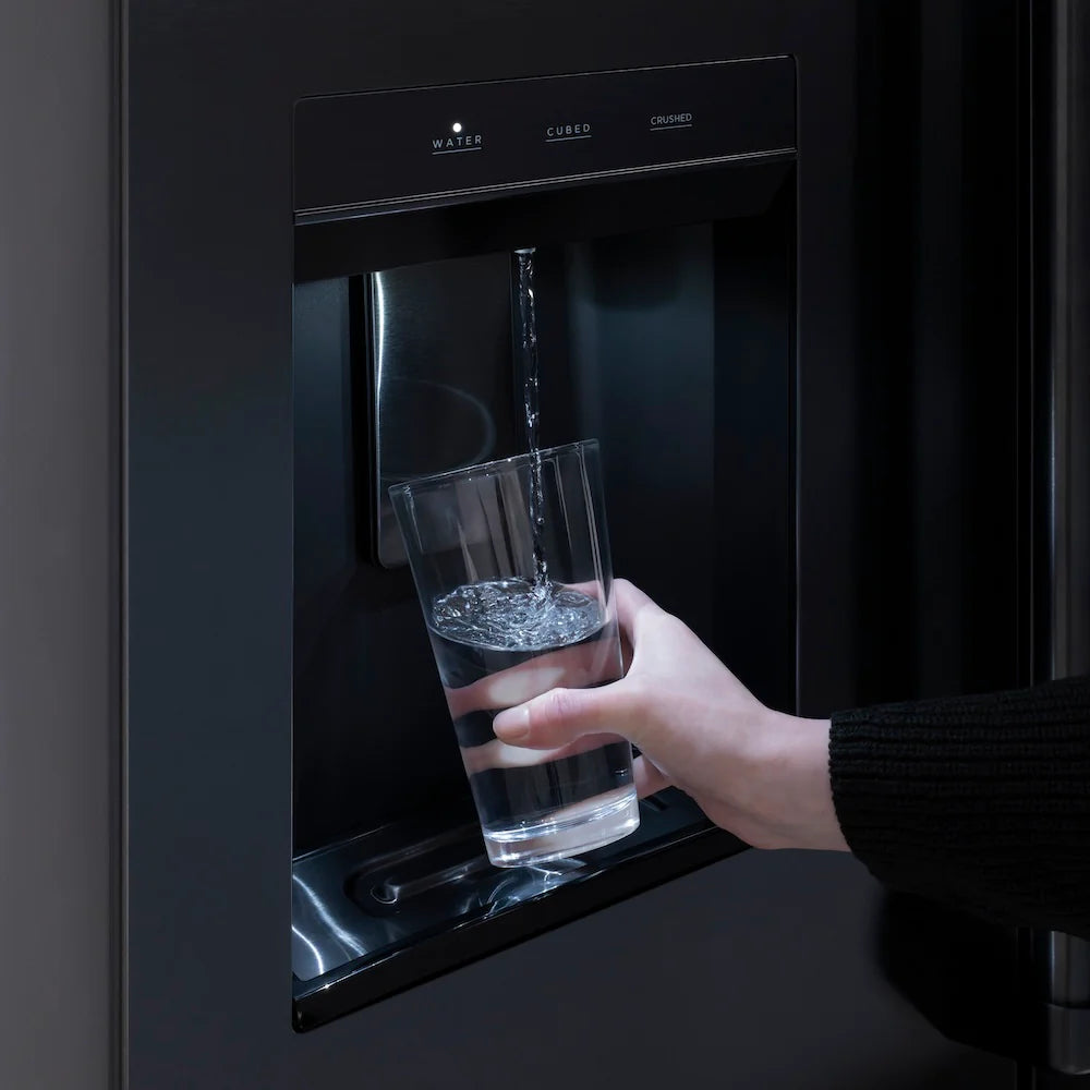 External water dispenser on a black stainless refrigerator with a hand holding water