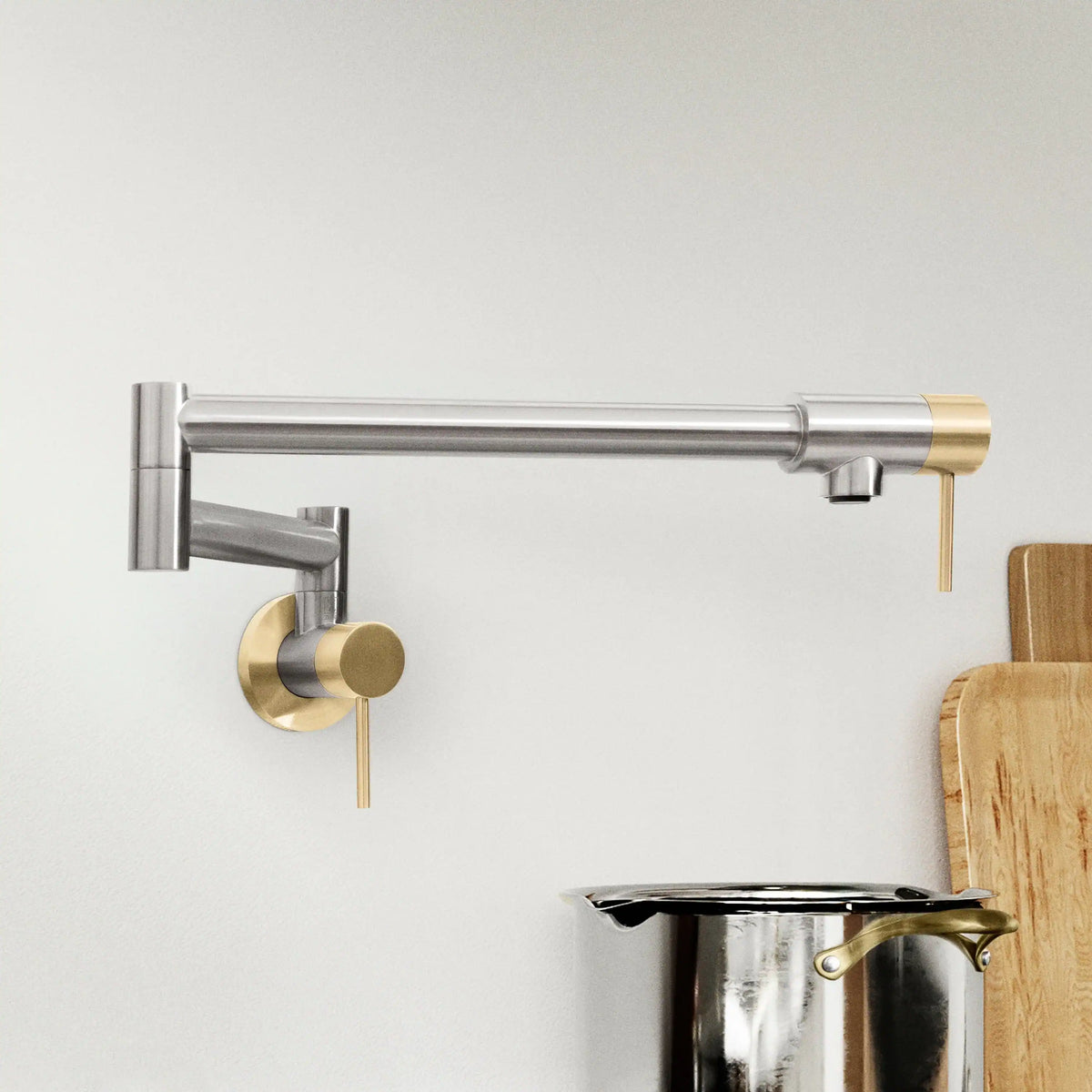 Wall-mounted pot filler spout over stove with brushed nickel and champagne bronze details