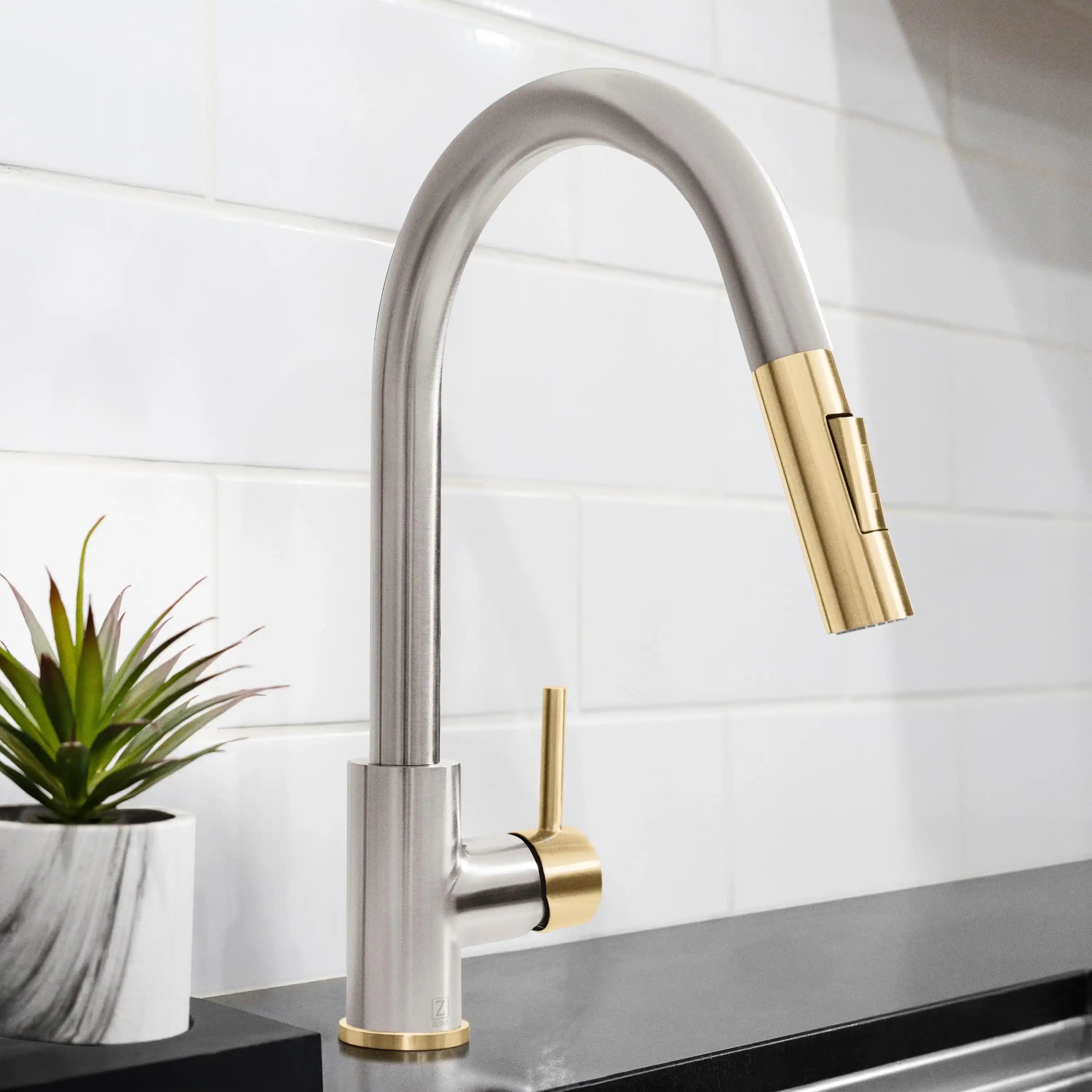 Brushed nickel kitchen faucet with high-arc spout and champagne bronze pull-down sprayer