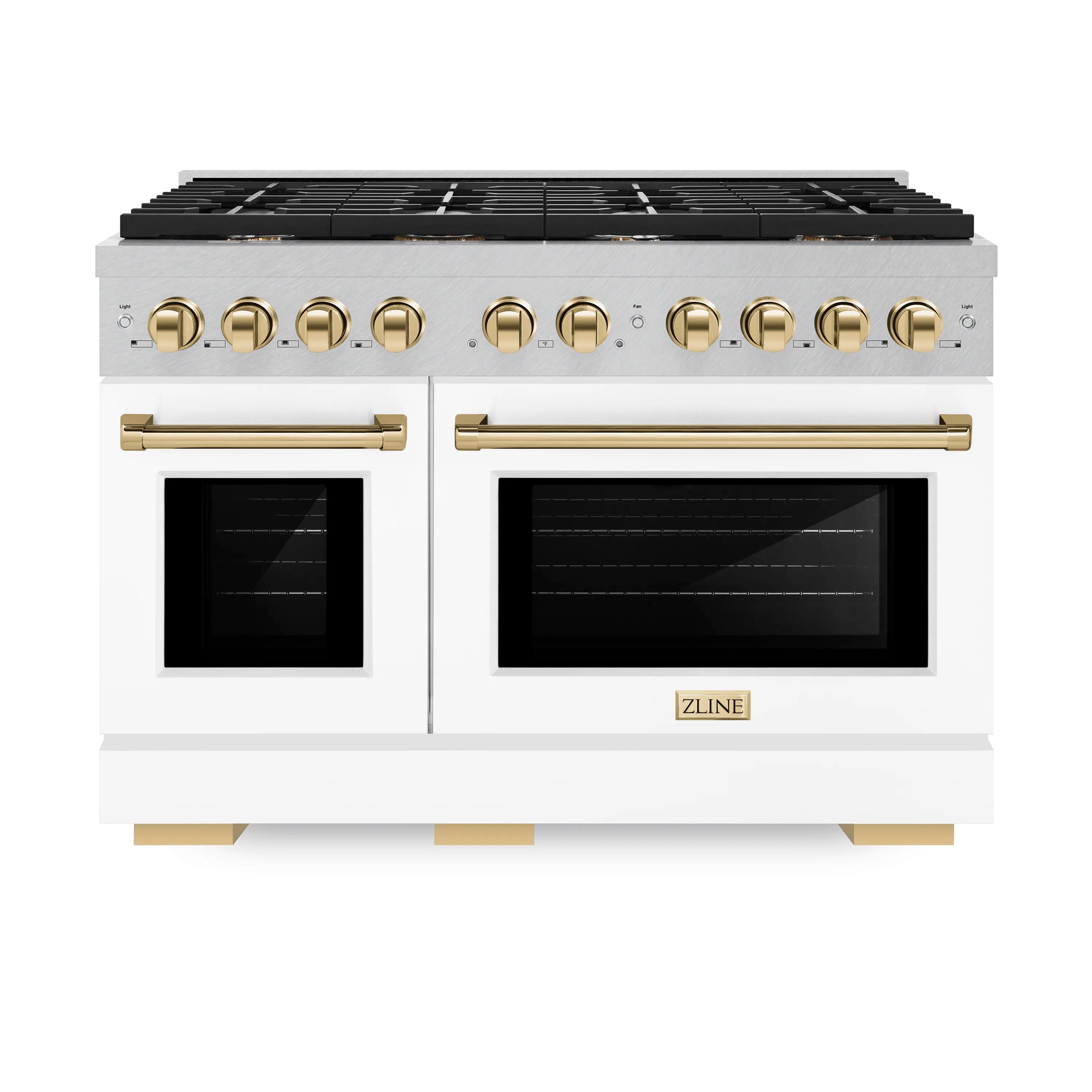 Dual-fuel range front with black cooktop grates, white oven doors, gold knobs
