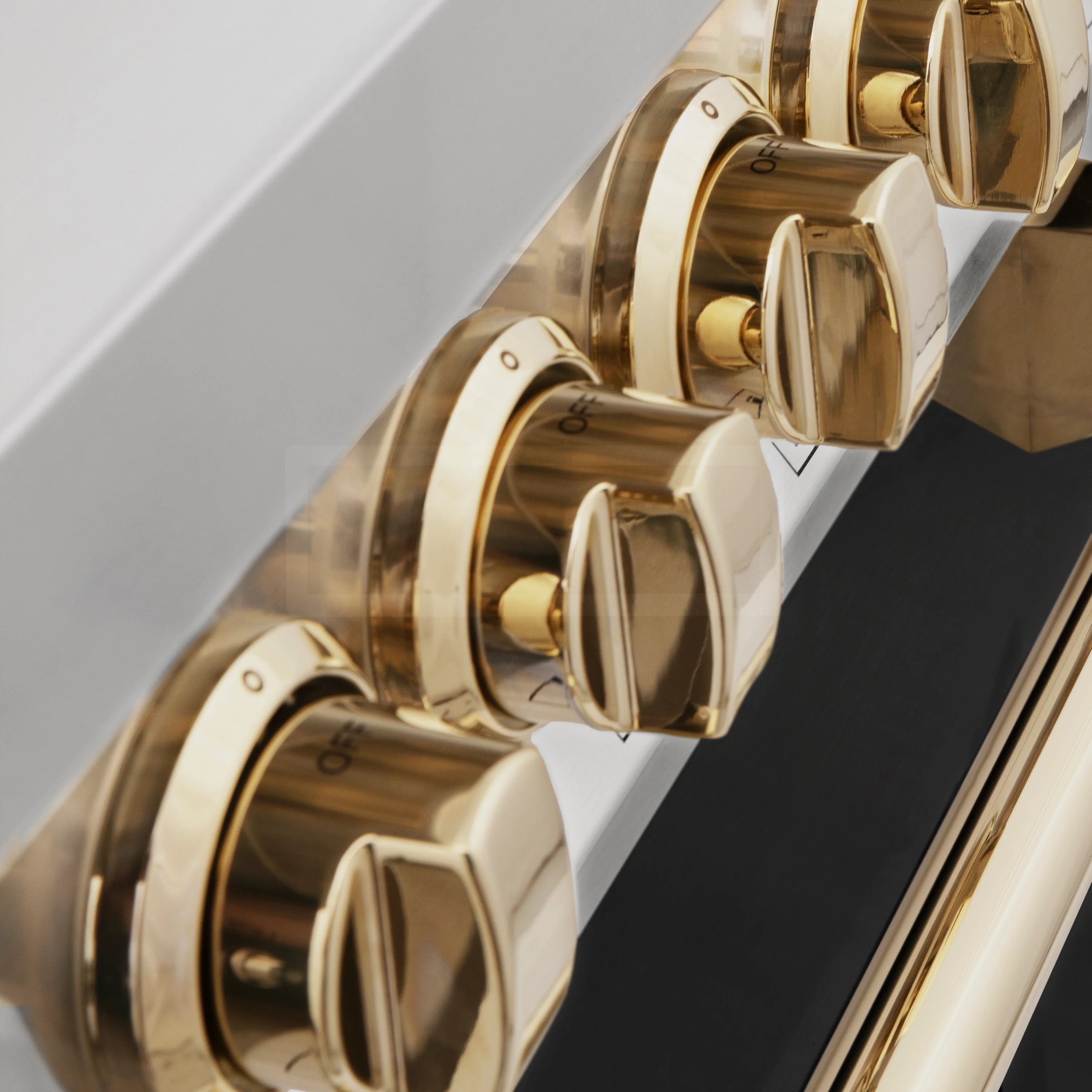Polished gold control knobs on a dark control panel