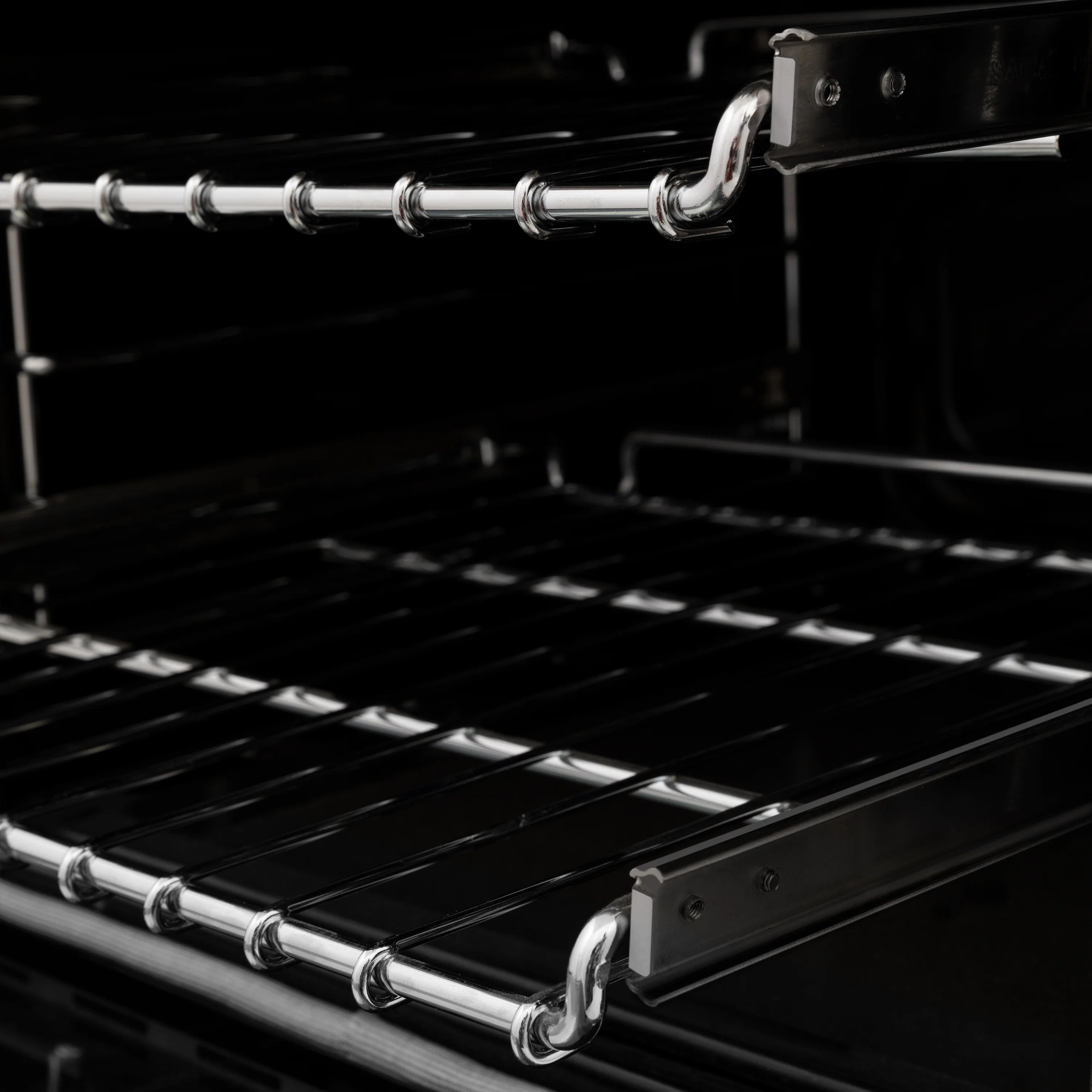 Oven cavity with chrome wire racks and black interior, viewed from above