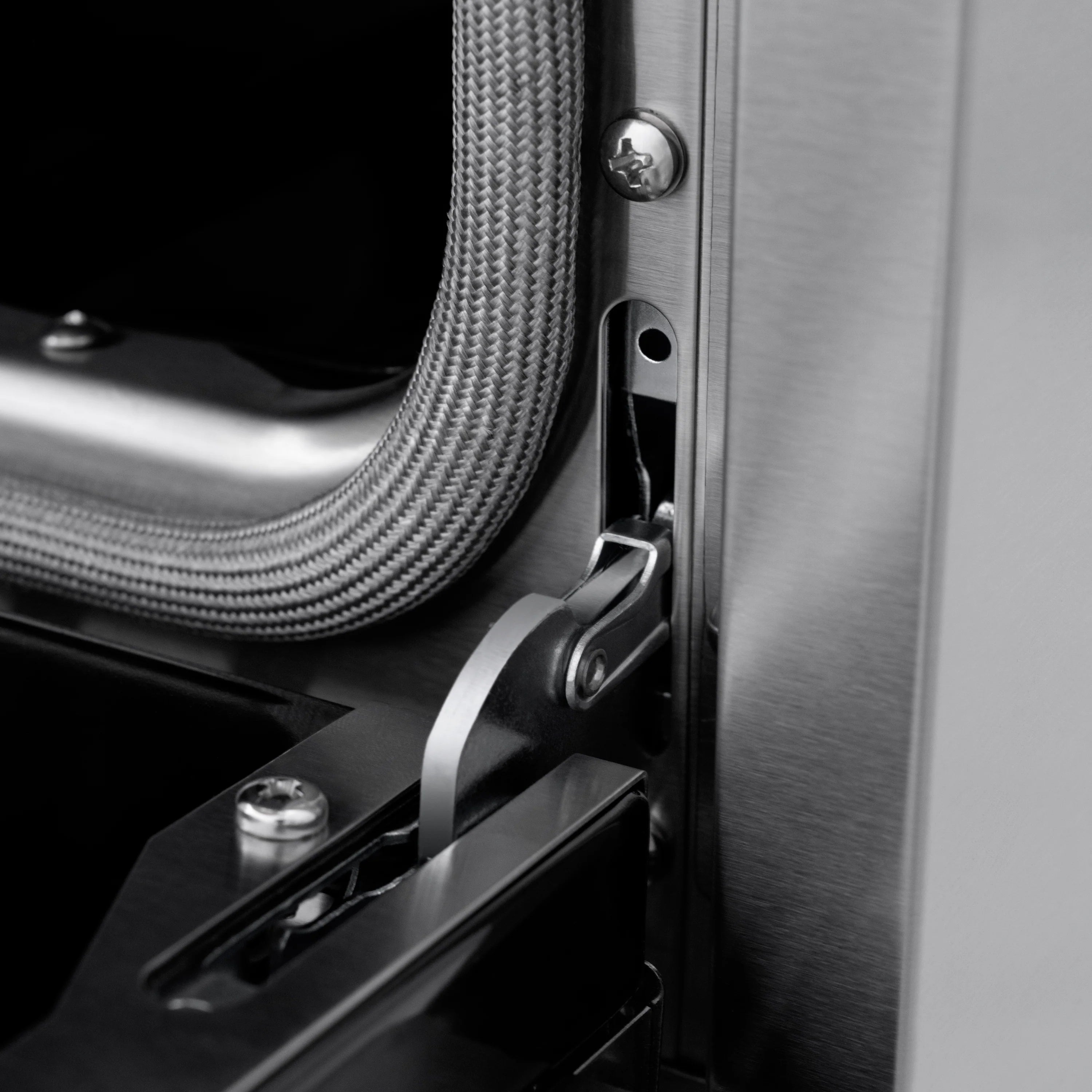 Stainless gas range side panel with door hinge and braided gas line connection
