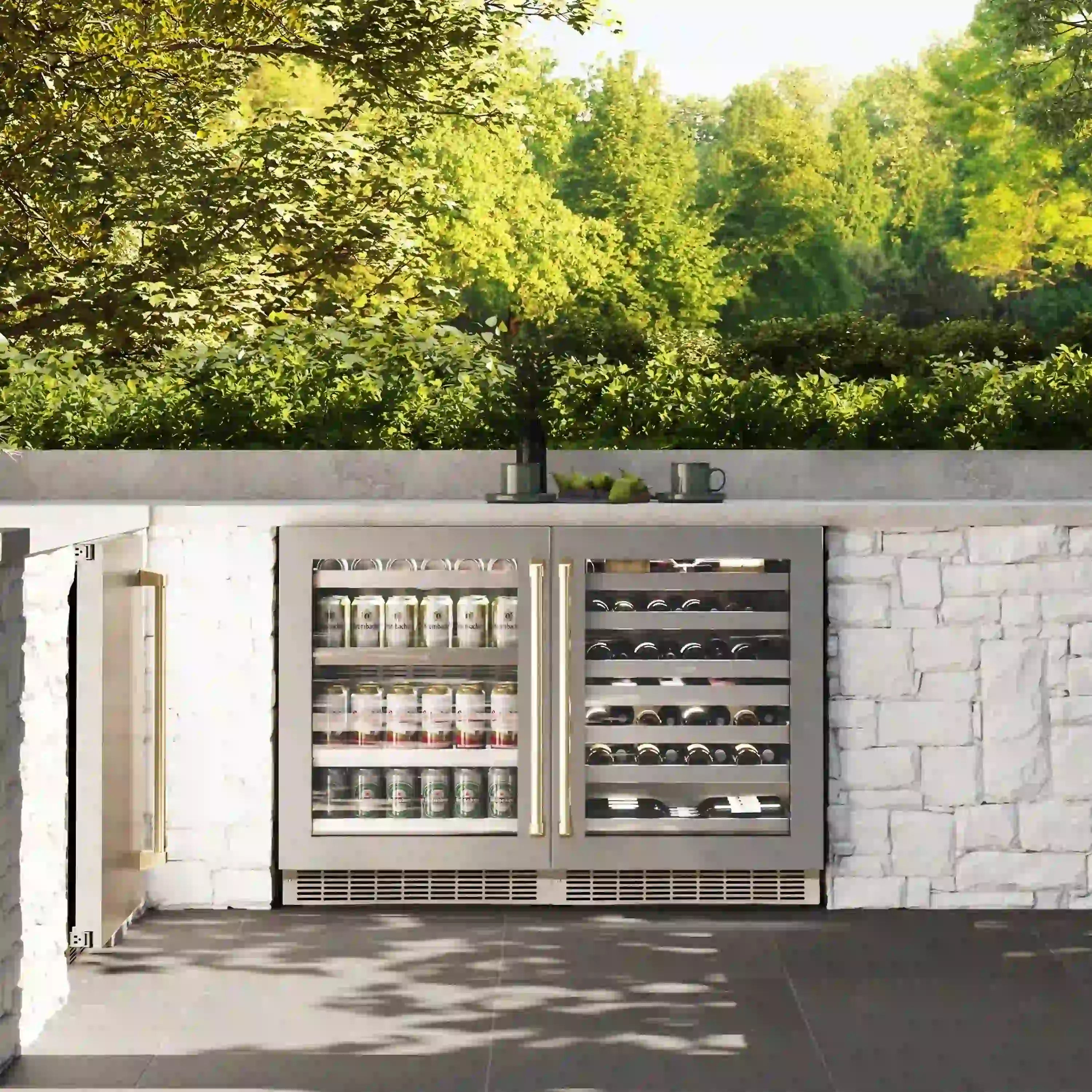 Built-in beverage fridge with open glass doors, stocked with bottles and cans