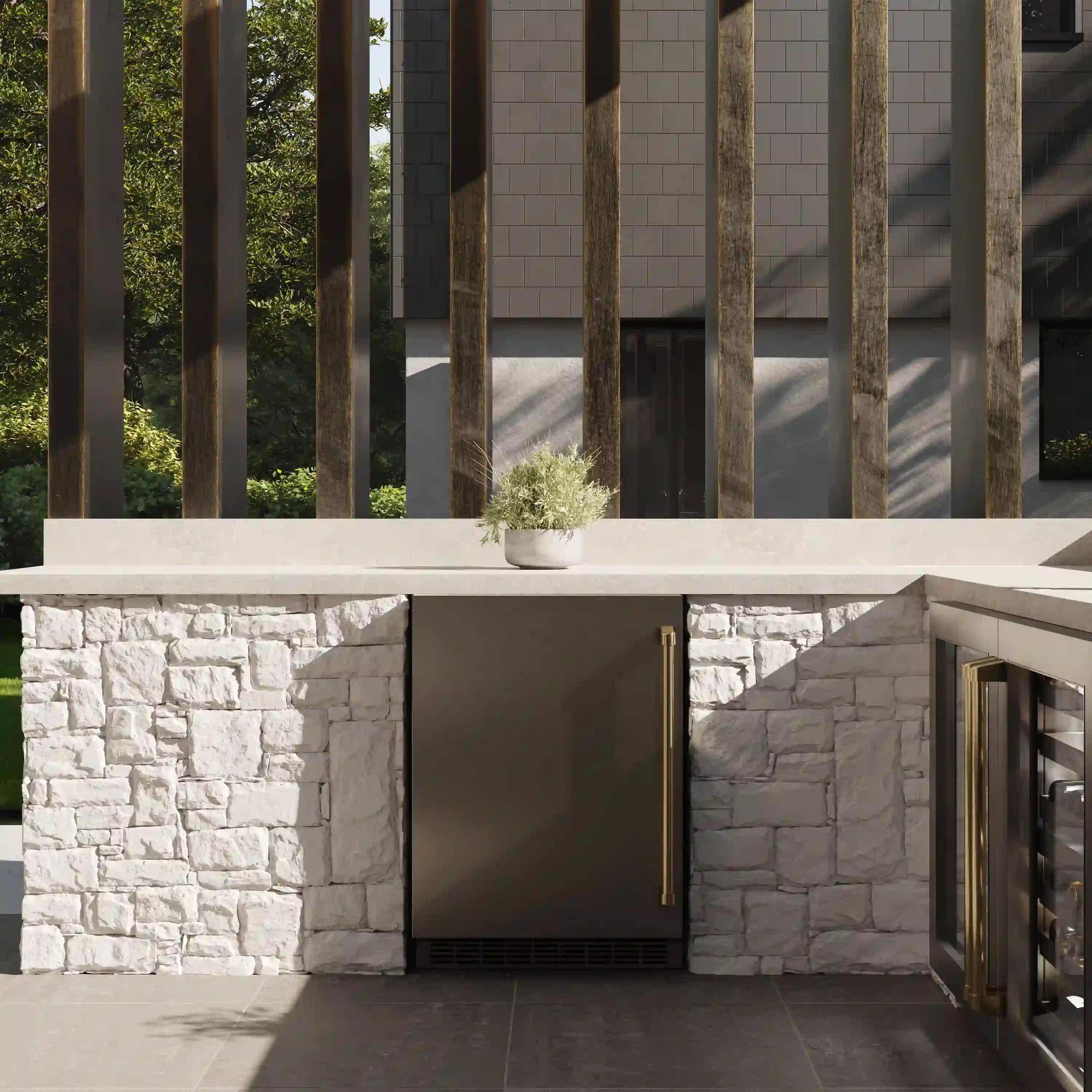 Built-in beverage fridge under outdoor counter with solid stainless door and gold handle