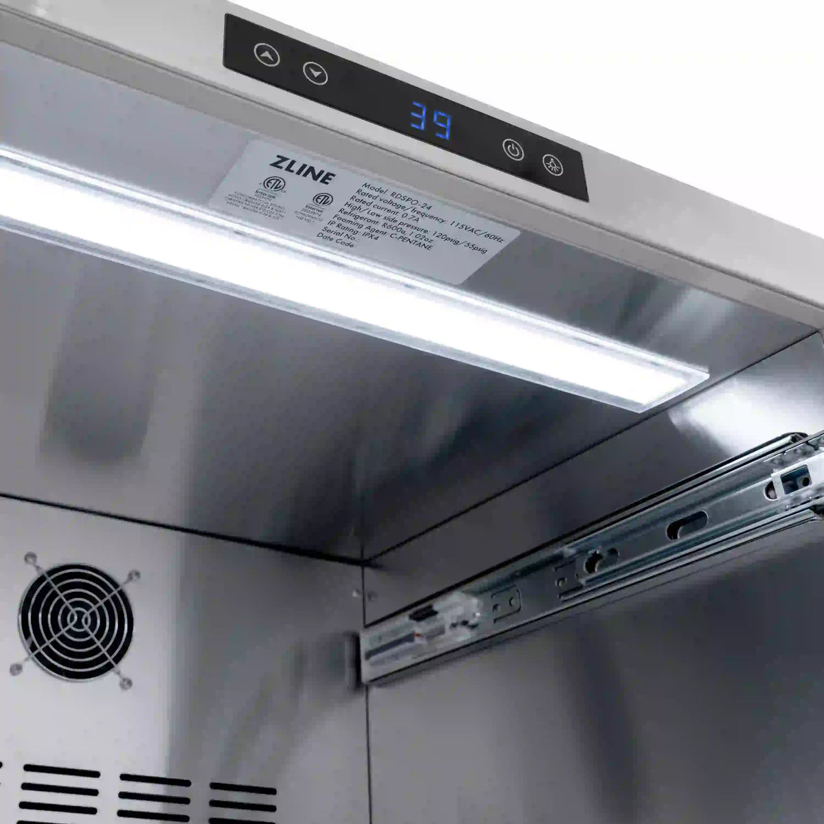 Outdoor refrigerator drawer front with black control panel and stainless interior lighting