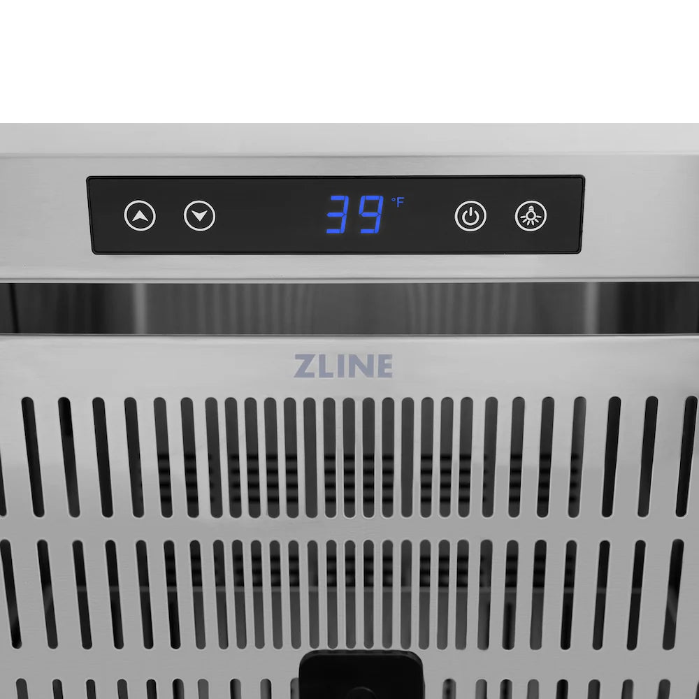 Refrigerator drawer front vent grille with dark slots and centered logo area