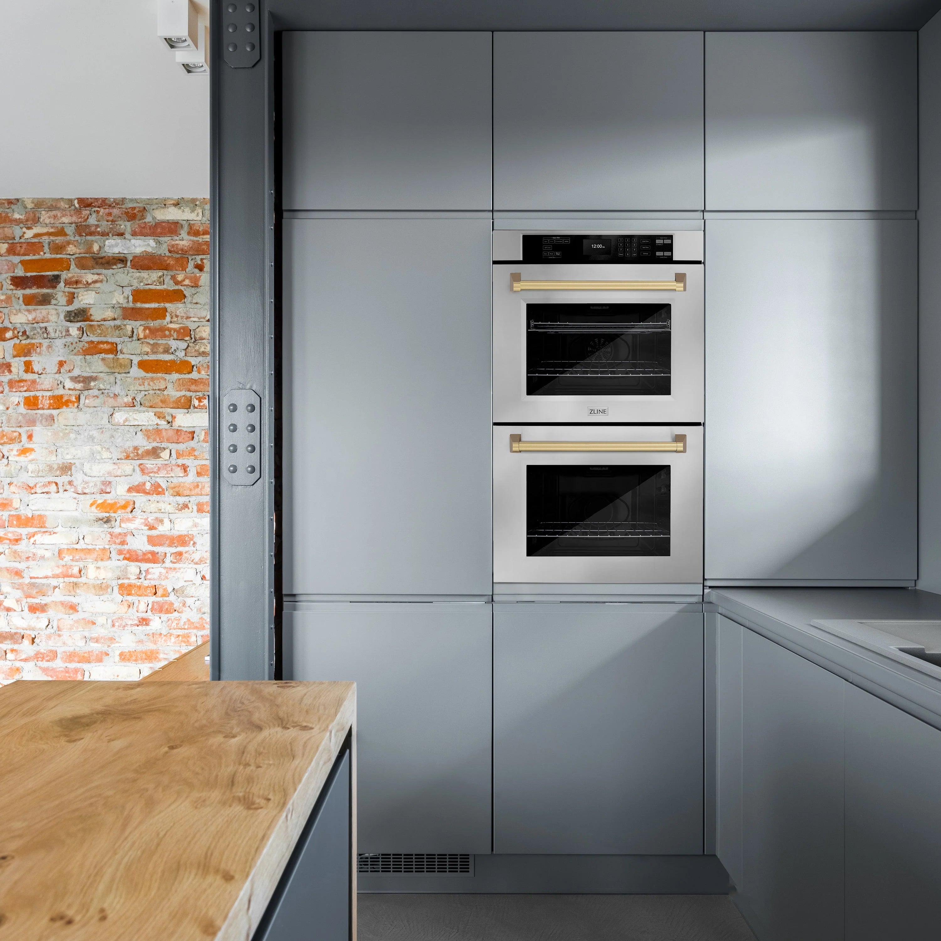 Built-in double wall oven with stainless doors and champagne bronze handle bars